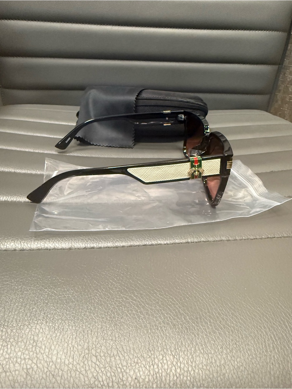 Black Sunglasses with Beige Accent and Green-Red Detail
